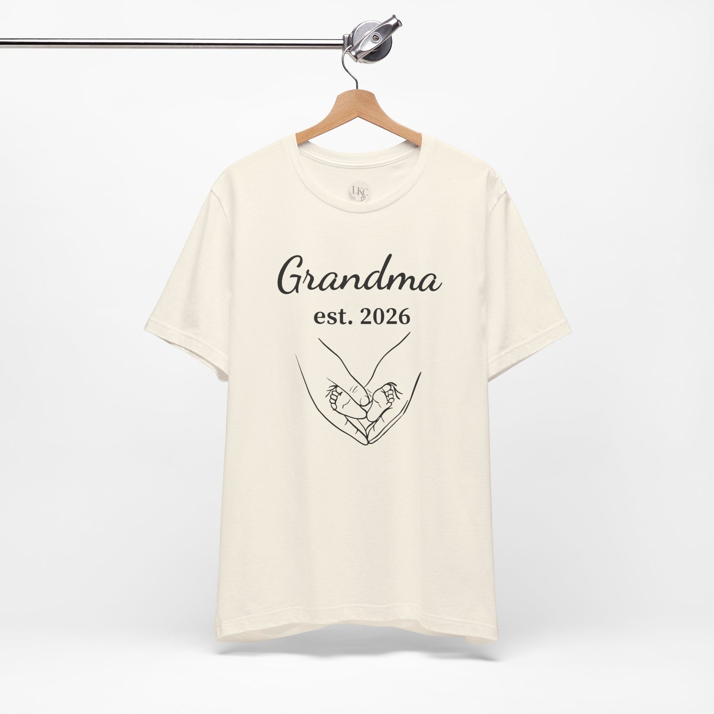 Grandma Est. 2026 T-Shirt — New Grandma Announcement Tee with Handholding Baby Illustration
