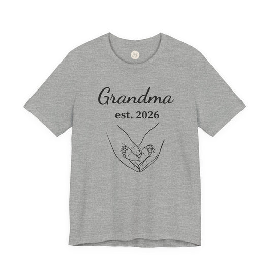 Grandma Est. 2026 T-Shirt — New Grandma Announcement Tee with Handholding Baby Illustration
