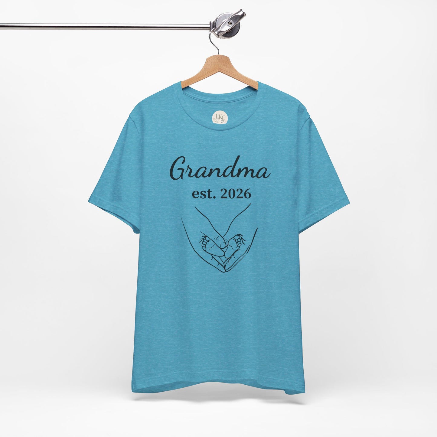 Grandma Est. 2026 T-Shirt — New Grandma Announcement Tee with Handholding Baby Illustration